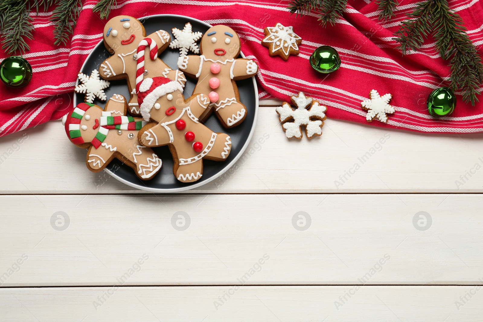 Photo of Delicious Christmas cookies and festive decor on white wooden table, flat lay. Space for text