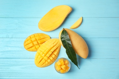 Photo of Flat lay composition with mango on wooden background