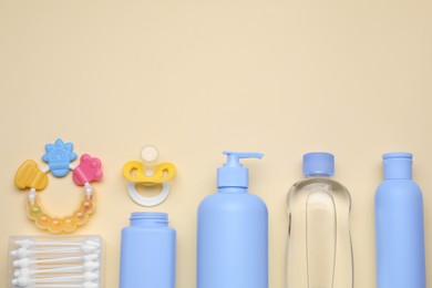 Flat lay composition with baby care products and accessories on beige background, space for text