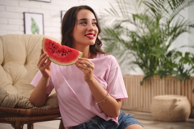 Photo of Beautiful young woman with watermelon at home