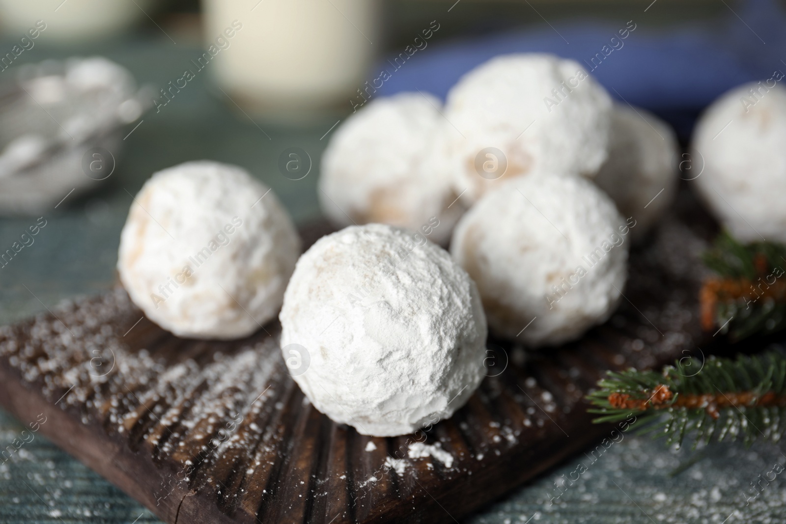 Photo of Tasty Christmas snowball cookies on table, closeup
