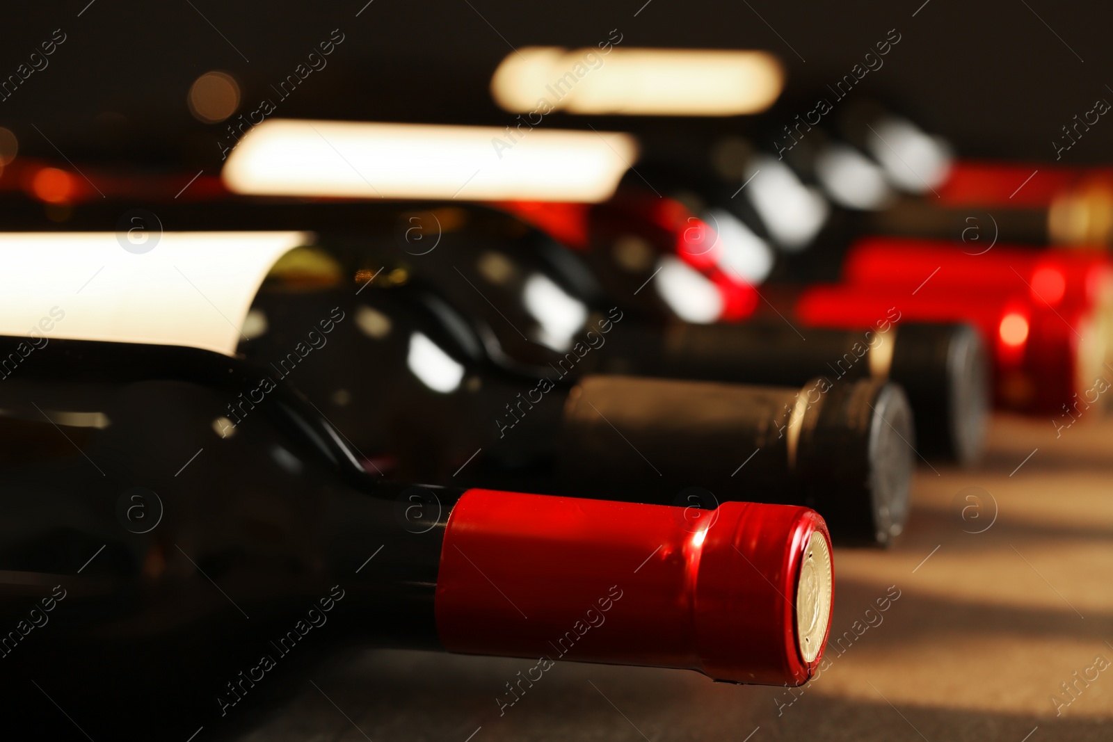 Photo of Bottles of different wines, closeup. Expensive collection