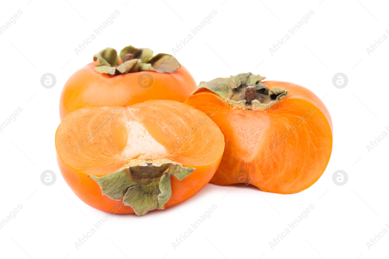 Photo of Whole and cut delicious ripe juicy persimmons on white background