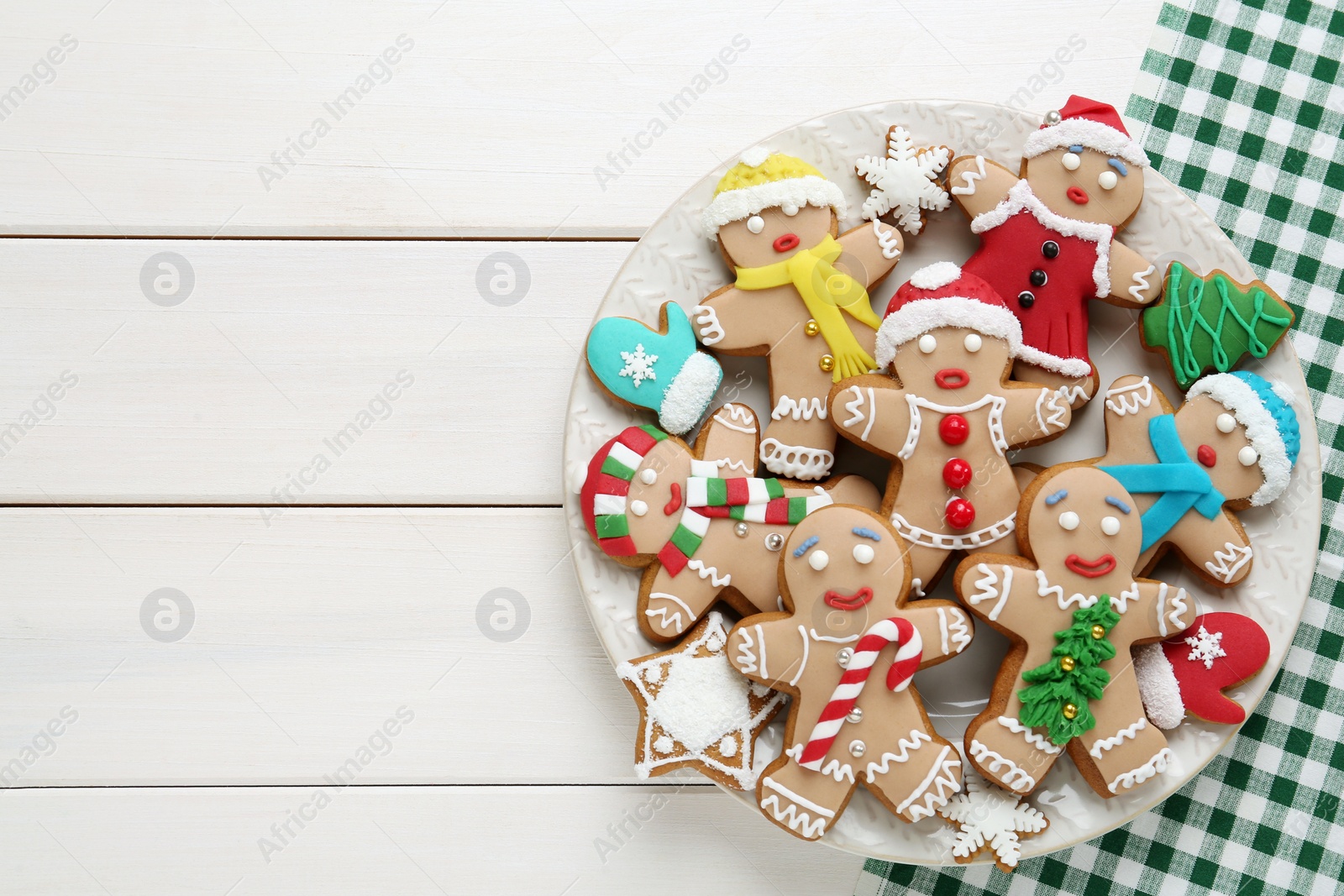 Photo of Delicious Christmas cookies on white wooden table, top view. Space for text