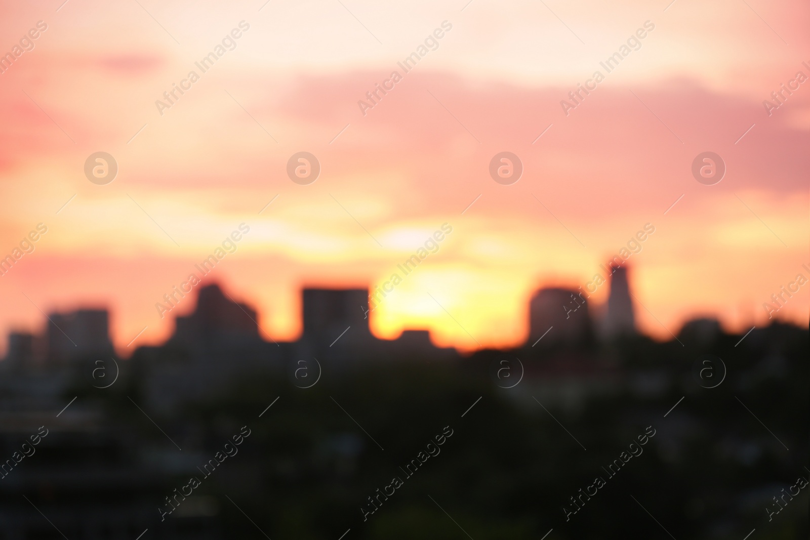 Photo of City district with modern buildings at sunset, bokeh effect