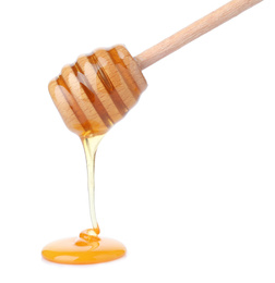 Honey pouring from wooden dipper isolated on white