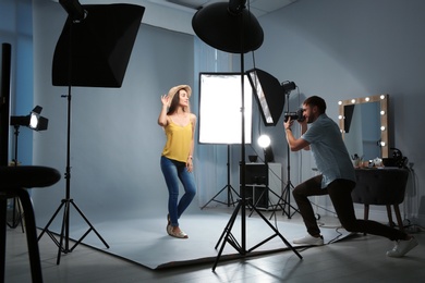 Beautiful model posing for professional photographer in studio