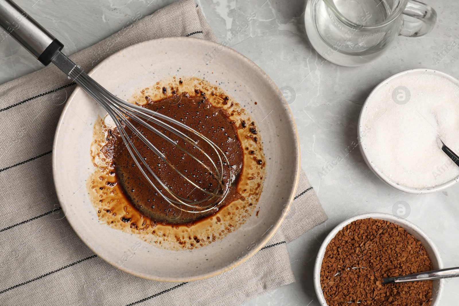 Photo of Whipping cream for dalgona coffee and ingredients on light gray table, flat lay