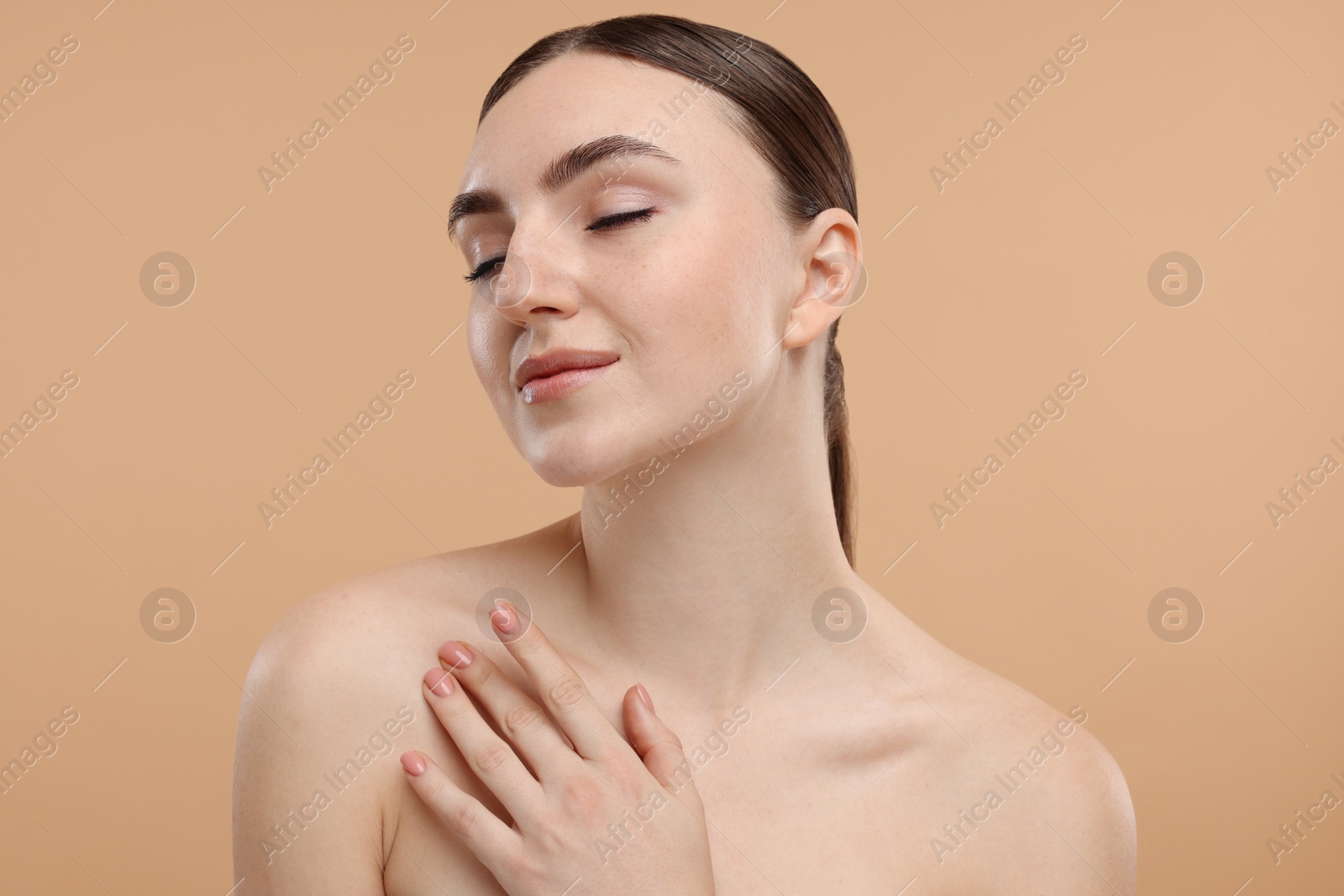 Photo of Portrait of beautiful woman on beige background