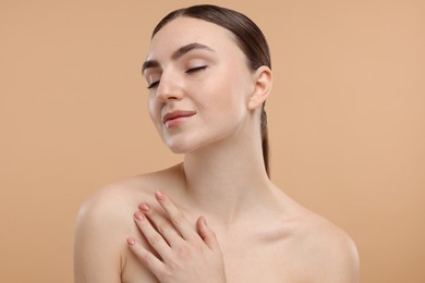 Photo of Portrait of beautiful woman on beige background