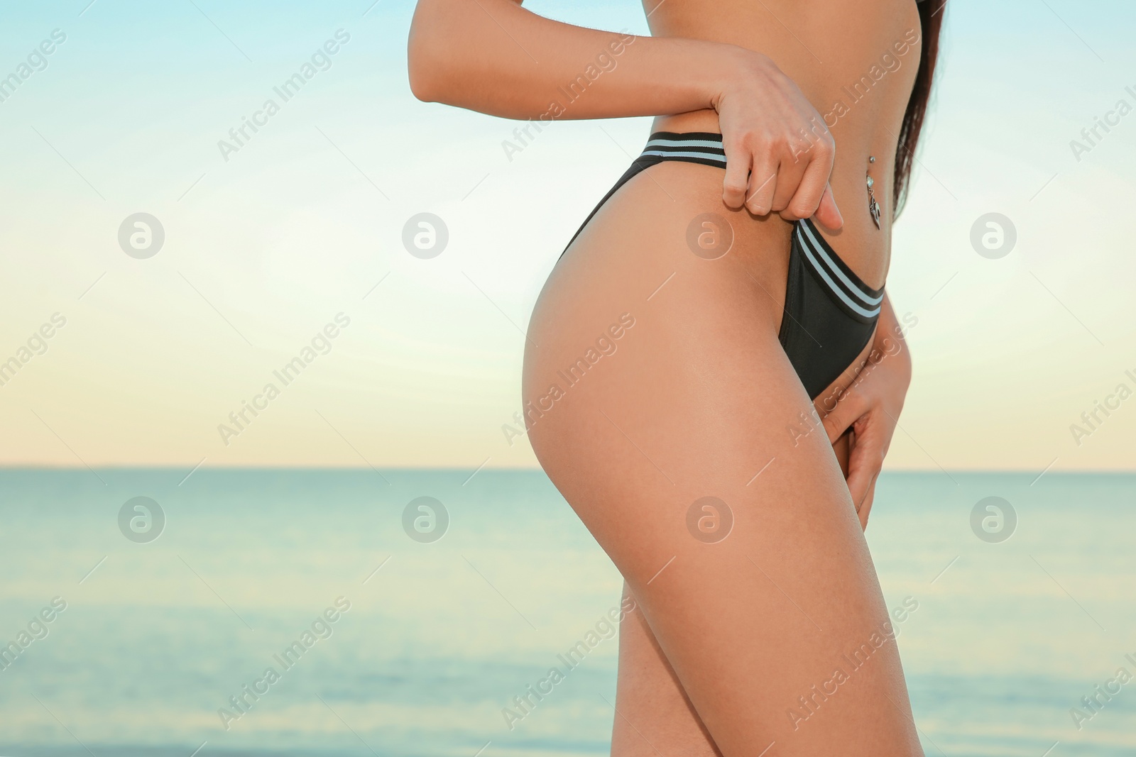 Photo of Young woman in swimsuit at seaside. Summer vacation