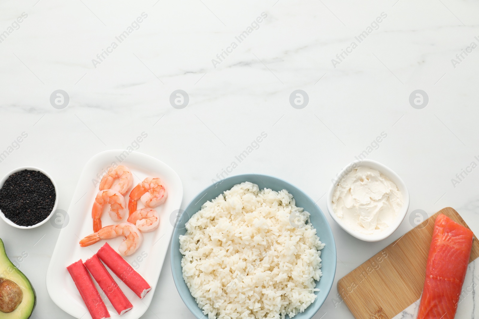Photo of Making sushi rolls. Flat lay composition with ingredients on white marble table. Space for text