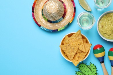 Flat lay composition with Mexican sombrero hat on light blue background, space for text