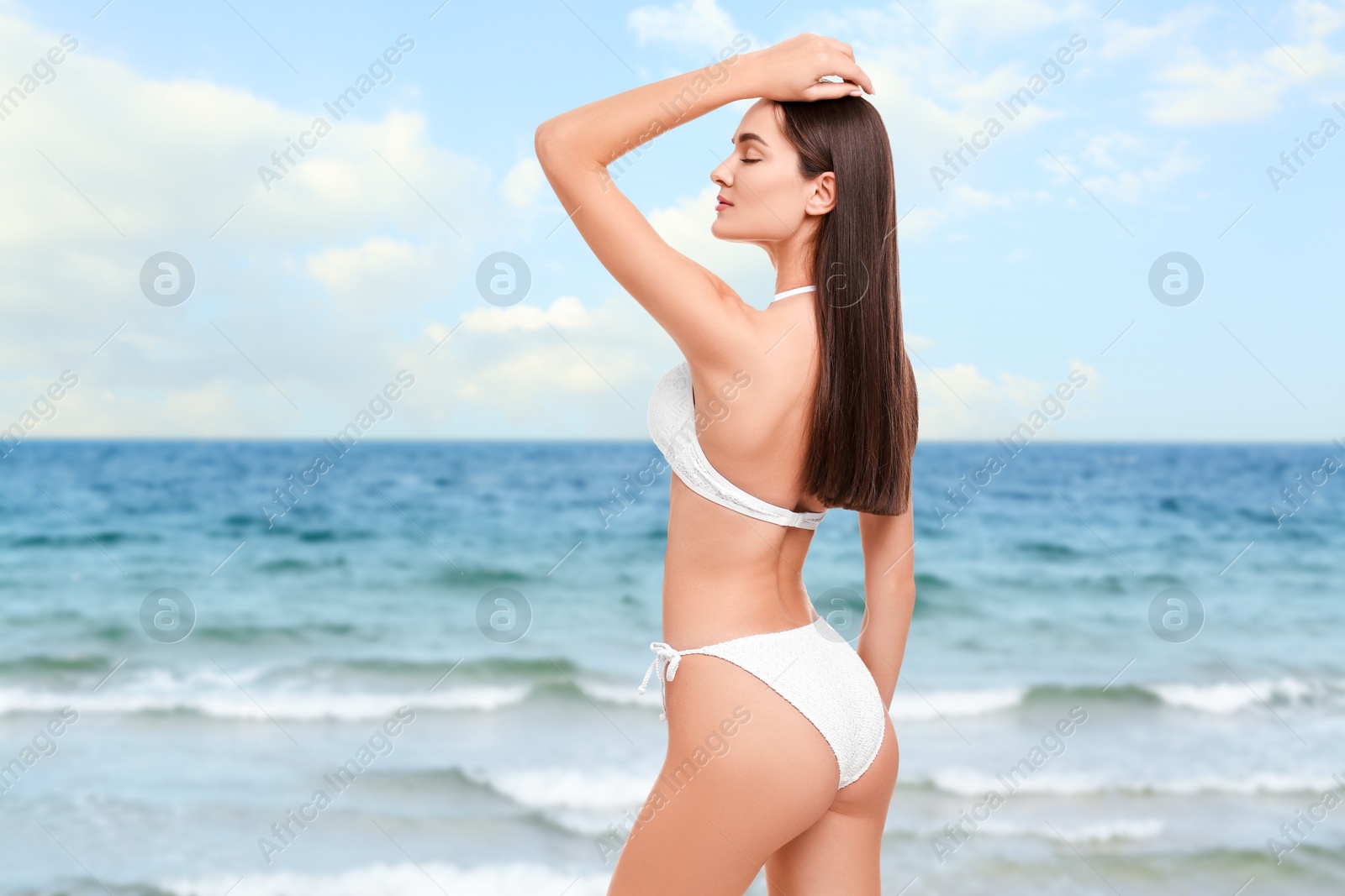 Image of Beautiful woman in stylish white bikini near sea, space for text