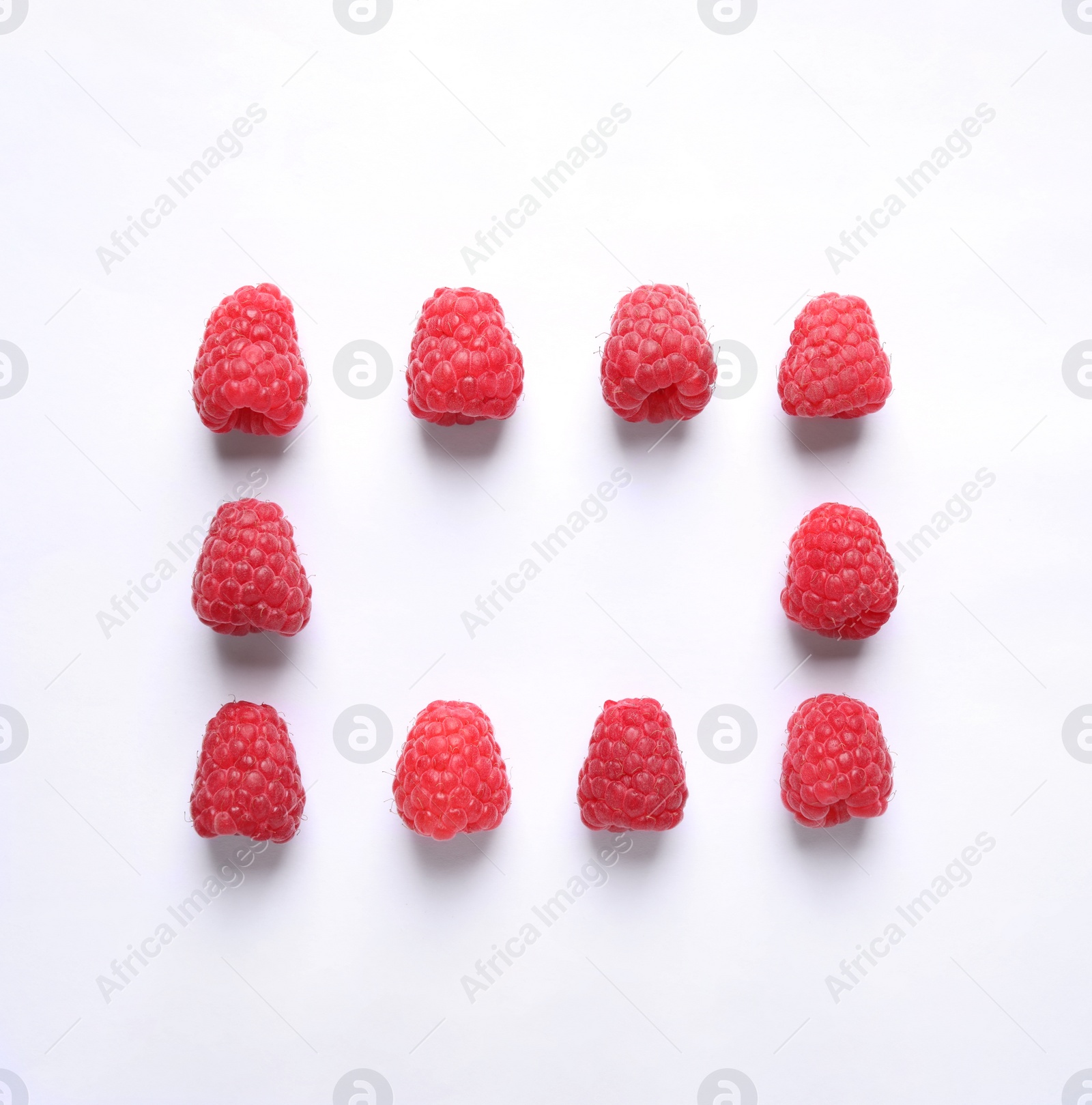 Photo of Frame of delicious ripe raspberries on white background, top view. Space for text