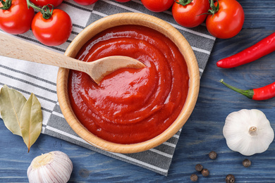 Photo of Flat lay composition with tomato sauce on blue wooden background