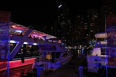 DUBAI, UNITED ARAB EMIRATES - NOVEMBER 03, 2018: Pier with luxury yachts at night