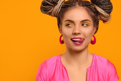 Beautiful woman with braided double buns on yellow background, space for text