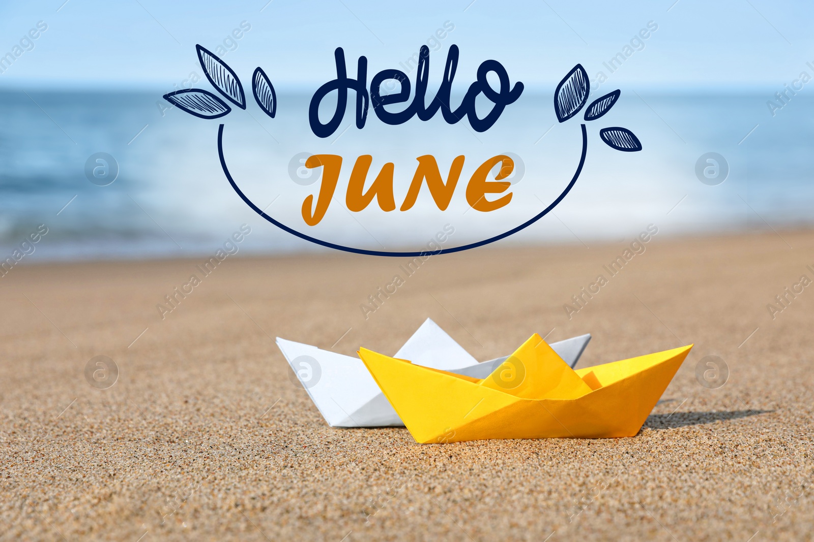 Image of Hello June. Color paper boats on sandy beach near sea
