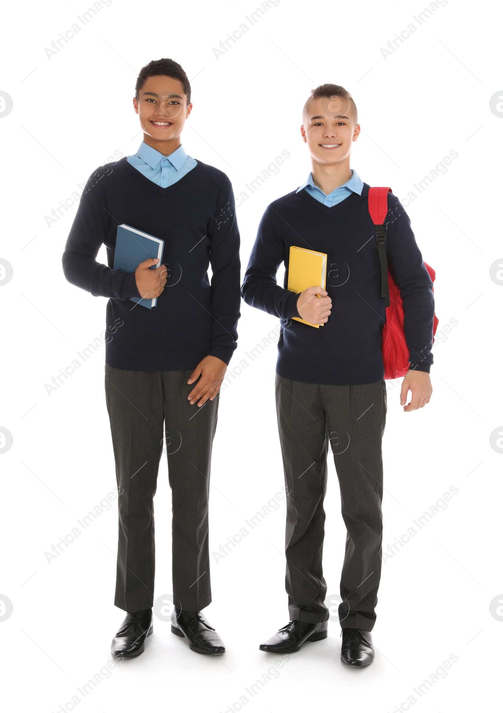 Photo of Full length portrait of teenage boys in school uniform on white background