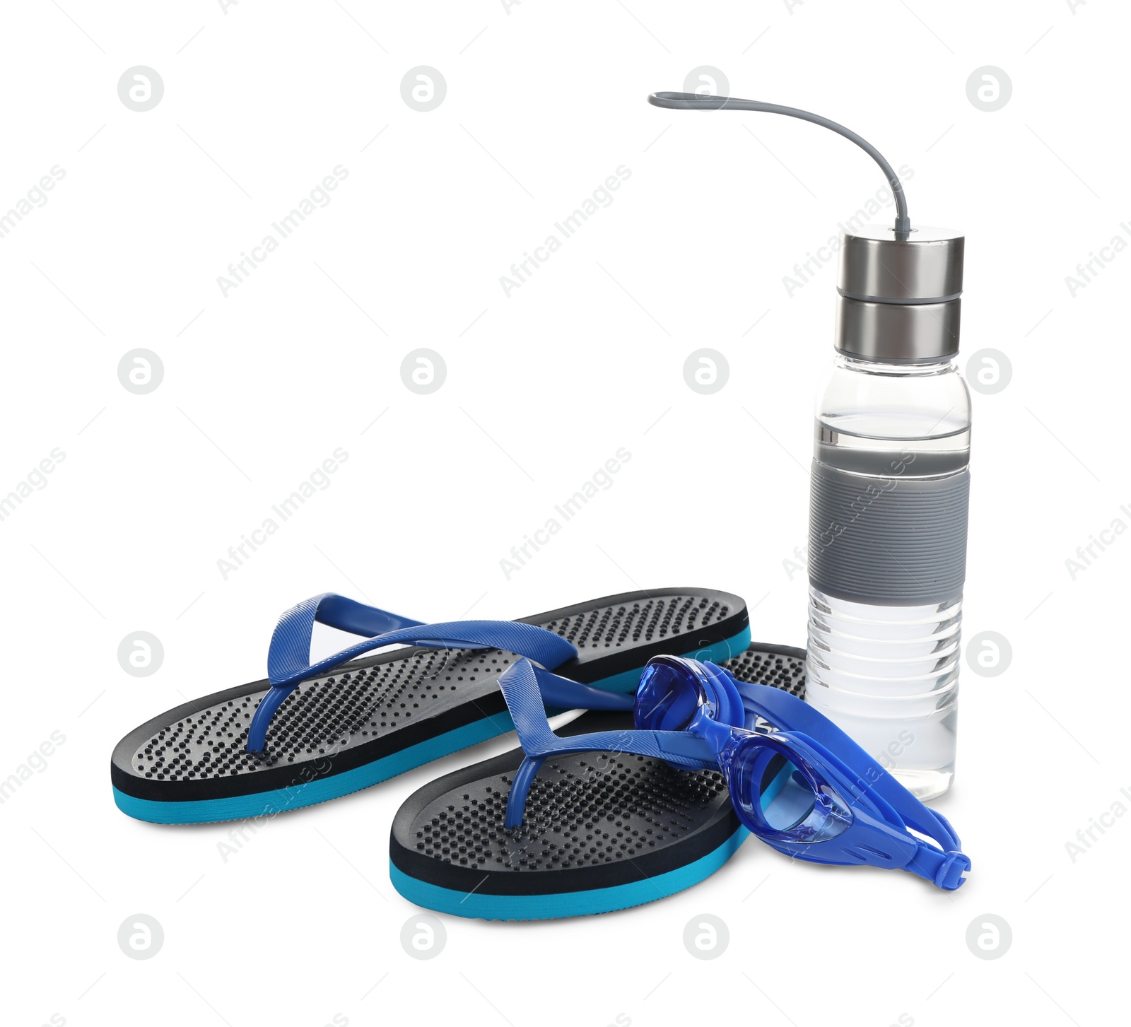 Photo of Swimming goggles, water bottle and flip flops isolated on white