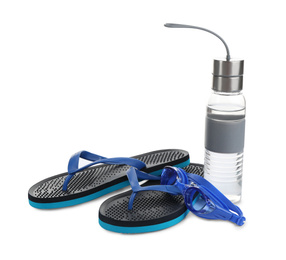 Photo of Swimming goggles, water bottle and flip flops isolated on white