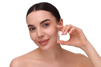 Beautiful young woman holding skincare ampoule on white background