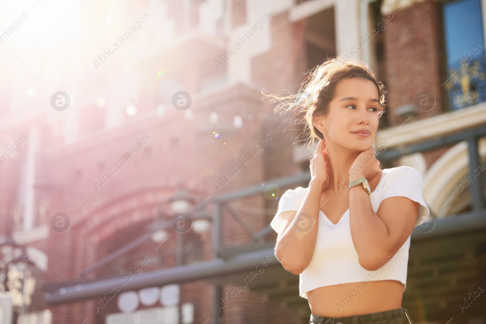 Photo of Portrait of happy young woman outdoors on sunny day. Space for text