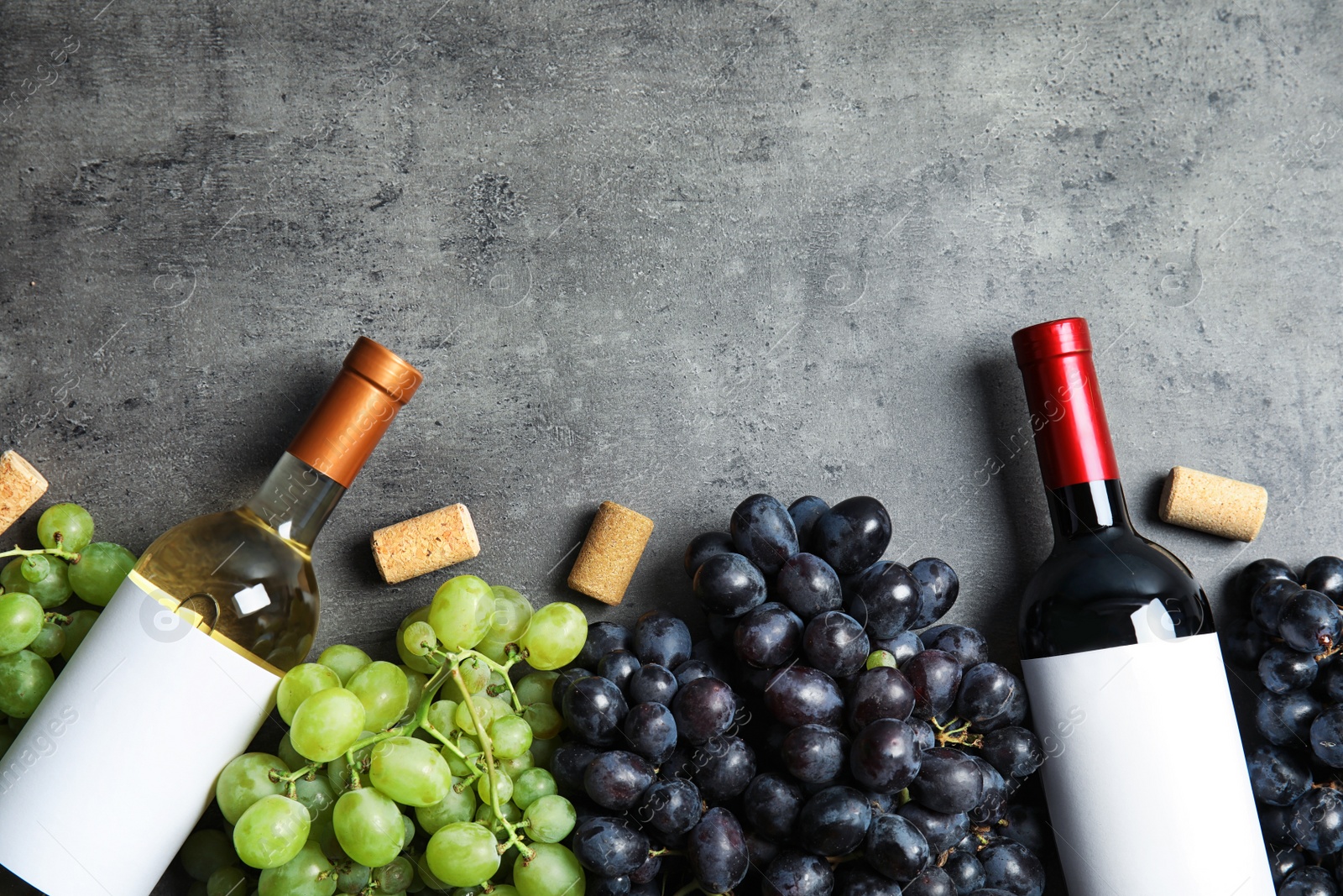 Photo of Flat lay composition with fresh ripe juicy grapes and space for text on table