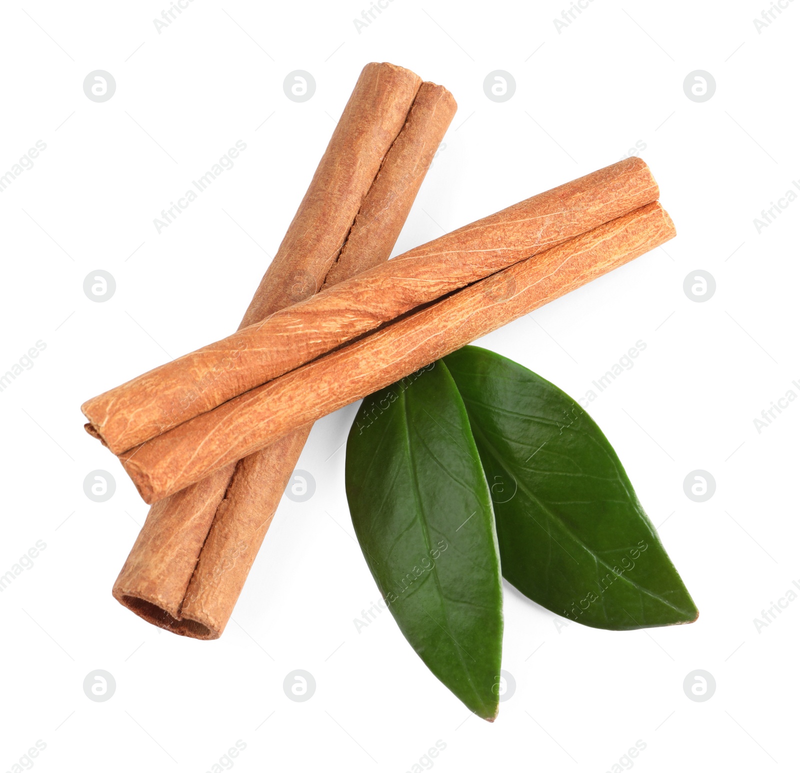 Photo of Cinnamon sticks and green leaves isolated on white, top view