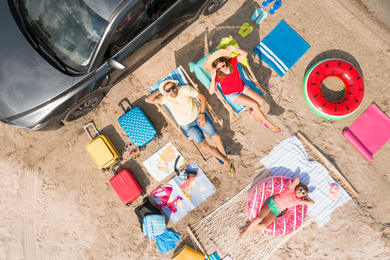 Image of Family with beach accessories and car near river, aerial view. Summer trip