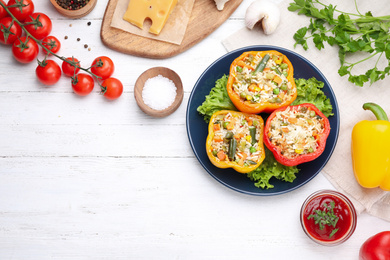 Photo of Flat lay composition with tasty stuffed bell peppers on white wooden table, space for text