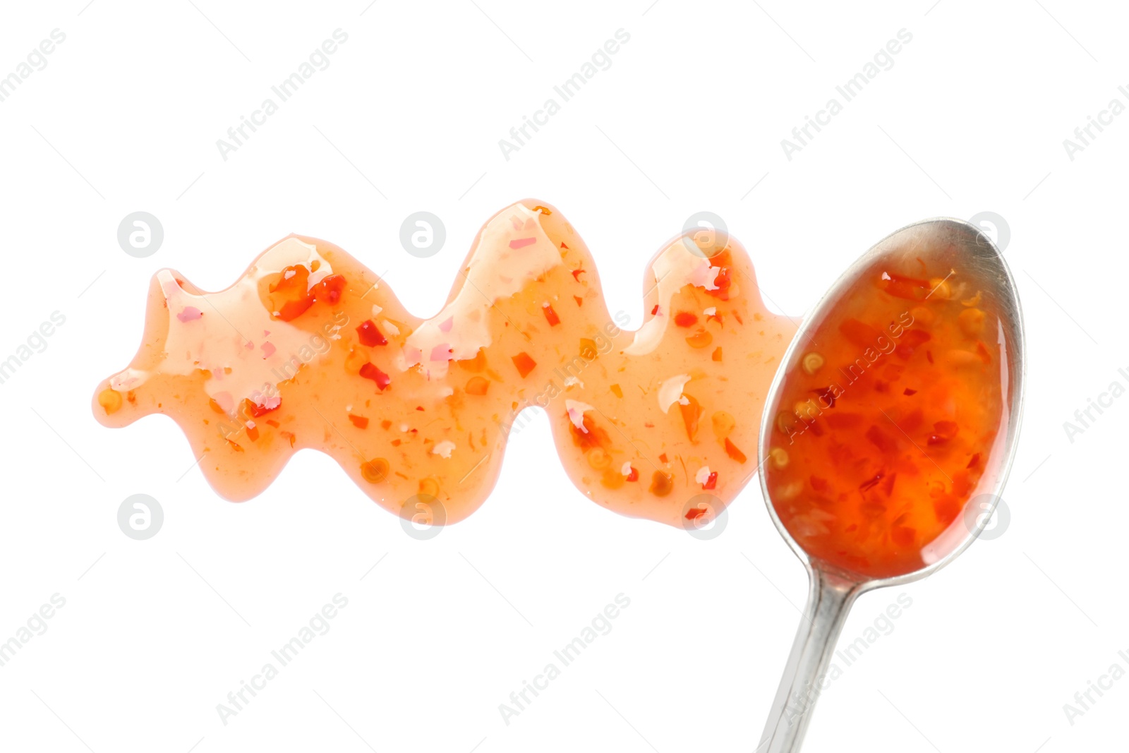 Photo of Delicious sweet chili sauce and spoon on white background, top view