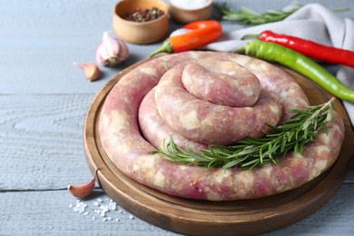 Photo of Homemade sausages and products on light grey wooden table, closeup