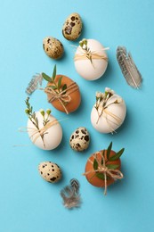 Festively decorated eggs on light blue background, flat lay. Happy Easter