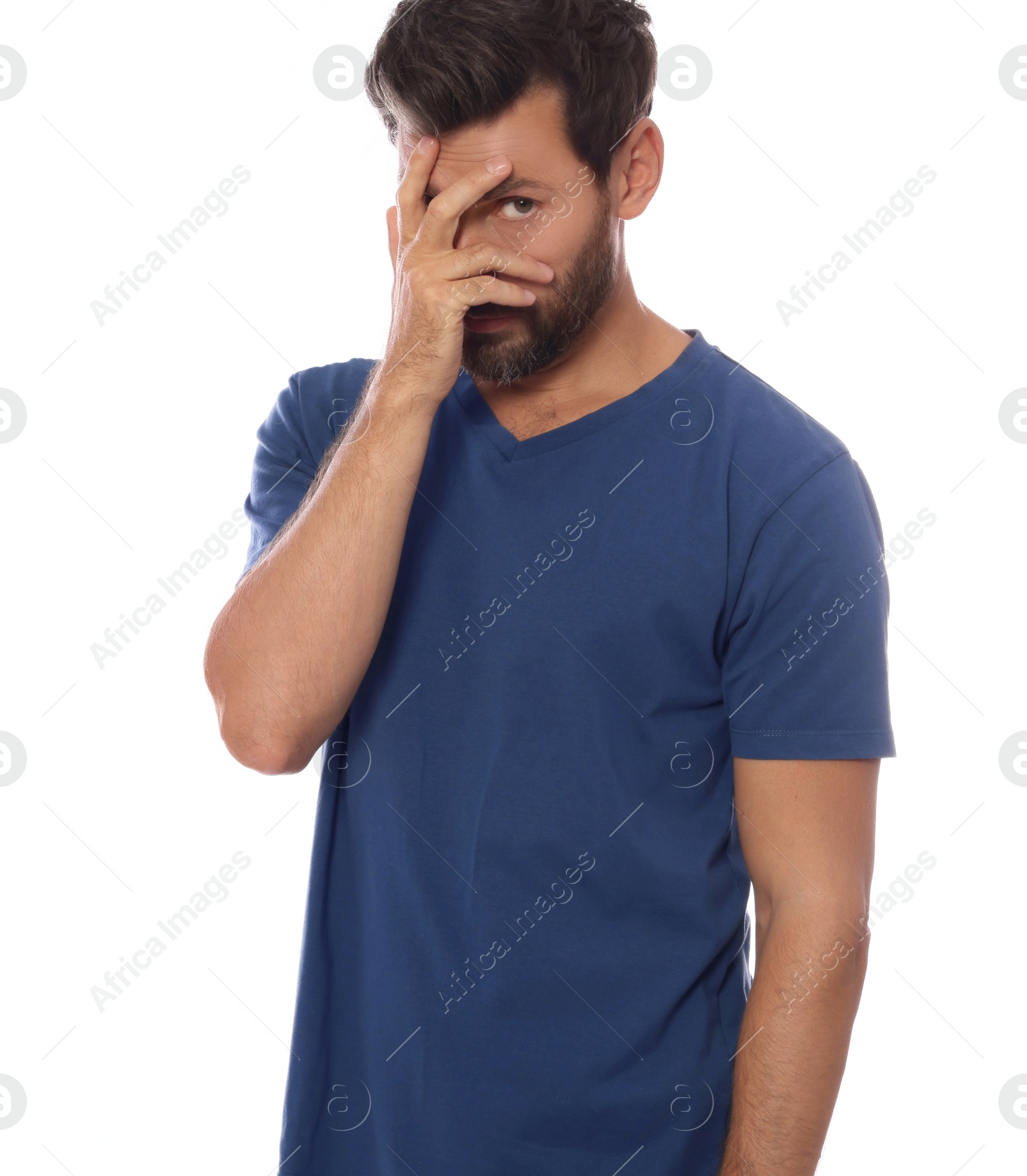 Photo of Embarrassed man covering face with hand on white background