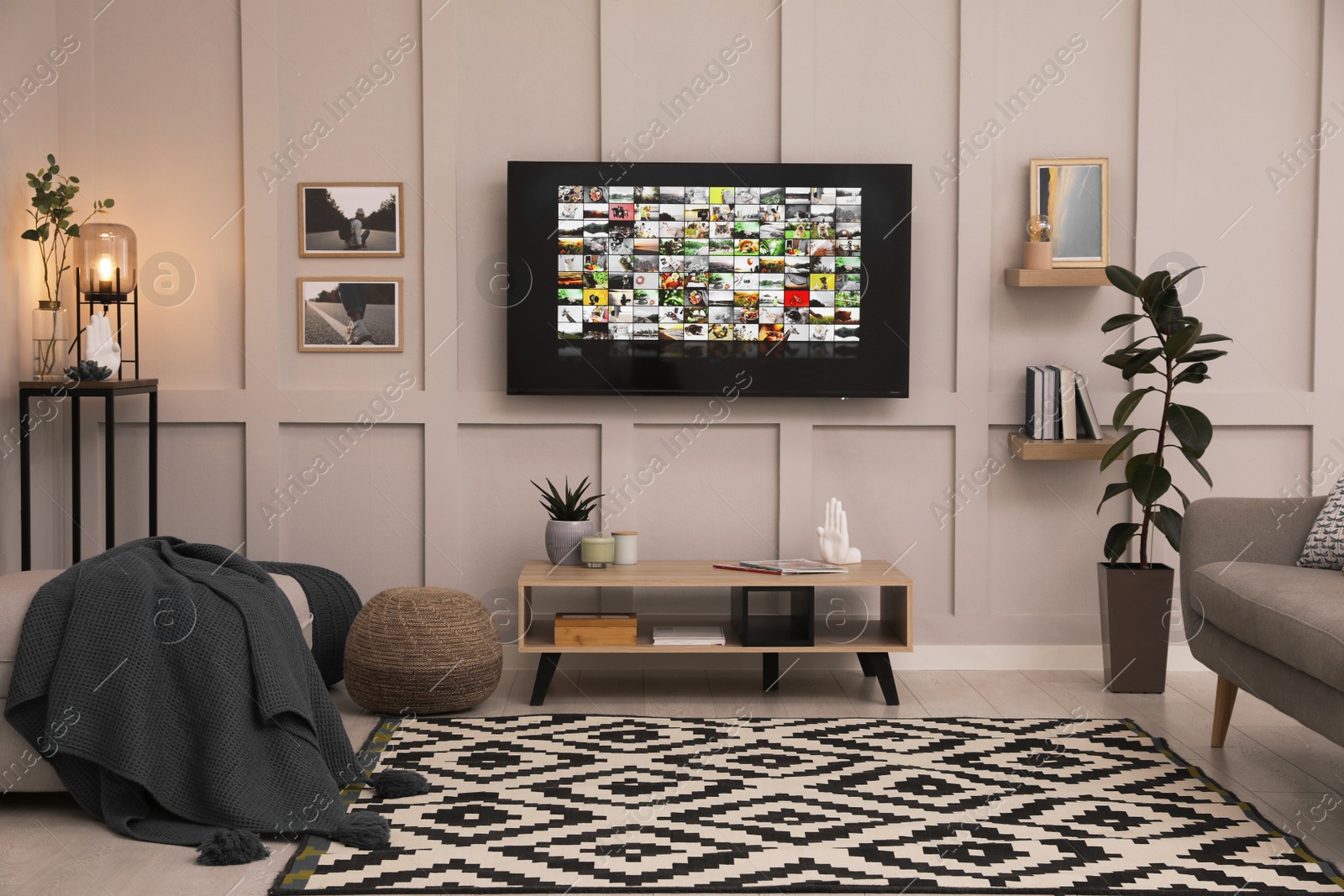 Photo of Stylish living room interior with modern TV on white wall