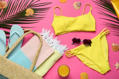 Flat lay composition with different beach objects on pink background