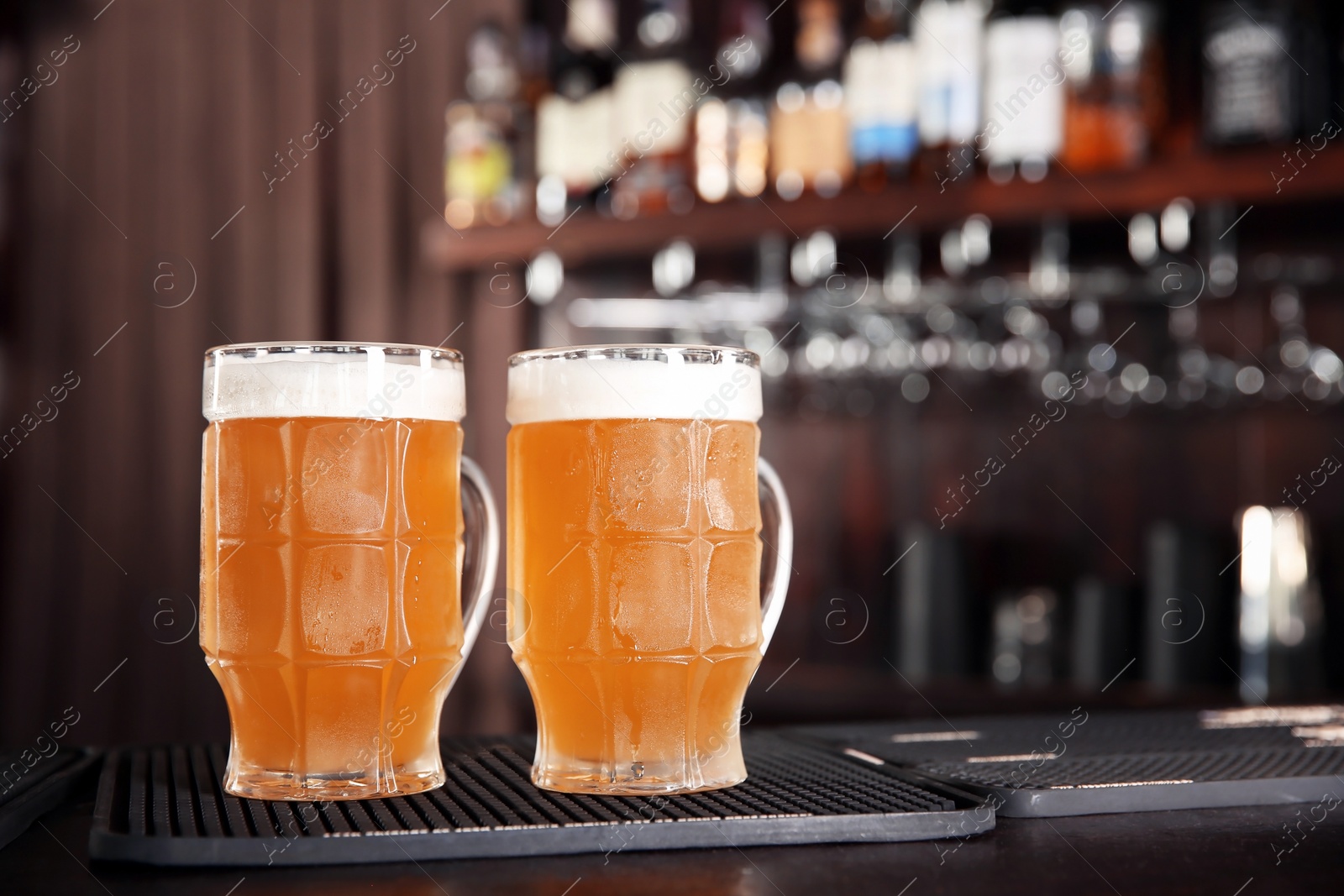 Photo of Glasses of tasty beer on bar counter