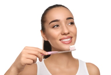 Photo of Woman holding toothbrush with paste on white background