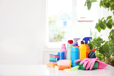 Photo of Set of cleaning supplies on table indoors