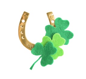 Golden horseshoe and decorative clover leaves on white background, top view. Saint Patrick's Day celebration