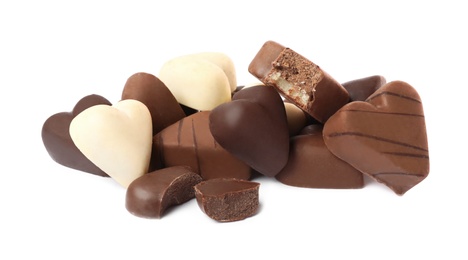 Delicious heart shaped chocolate candies on white background