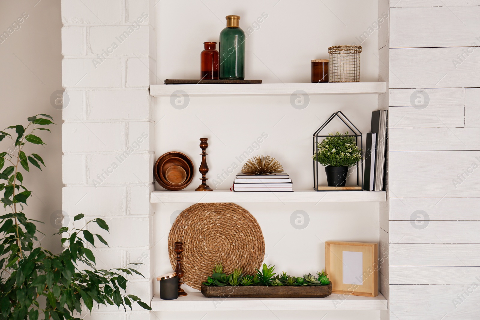 Photo of Wall shelves with beautiful decor elements indoors. Interior design