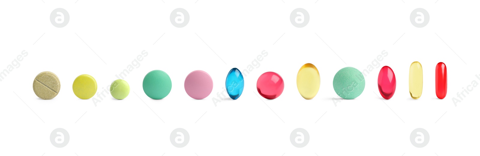 Image of Set of different color pills in row isolated on white