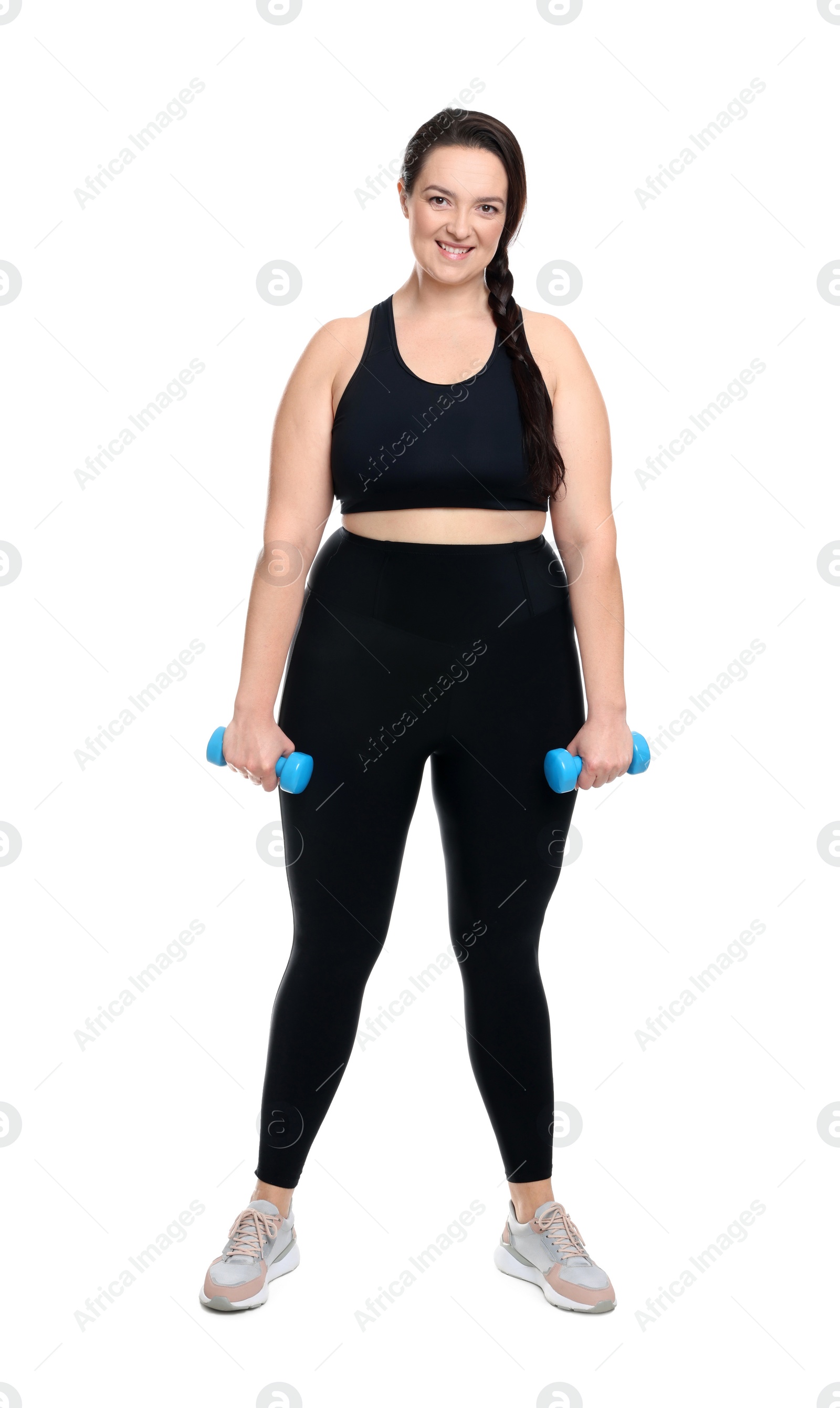 Photo of Happy overweight woman with dumbbells on white background