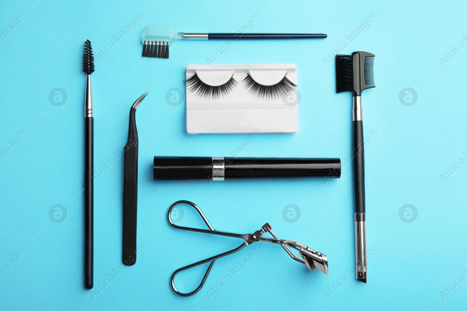 Photo of Flat lay composition of professional makeup tools and false eyelashes on color background