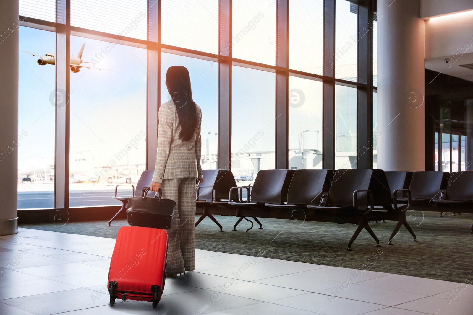 Image of Businesswoman with bag and travel suitcase at airport terminal. Summer vacation