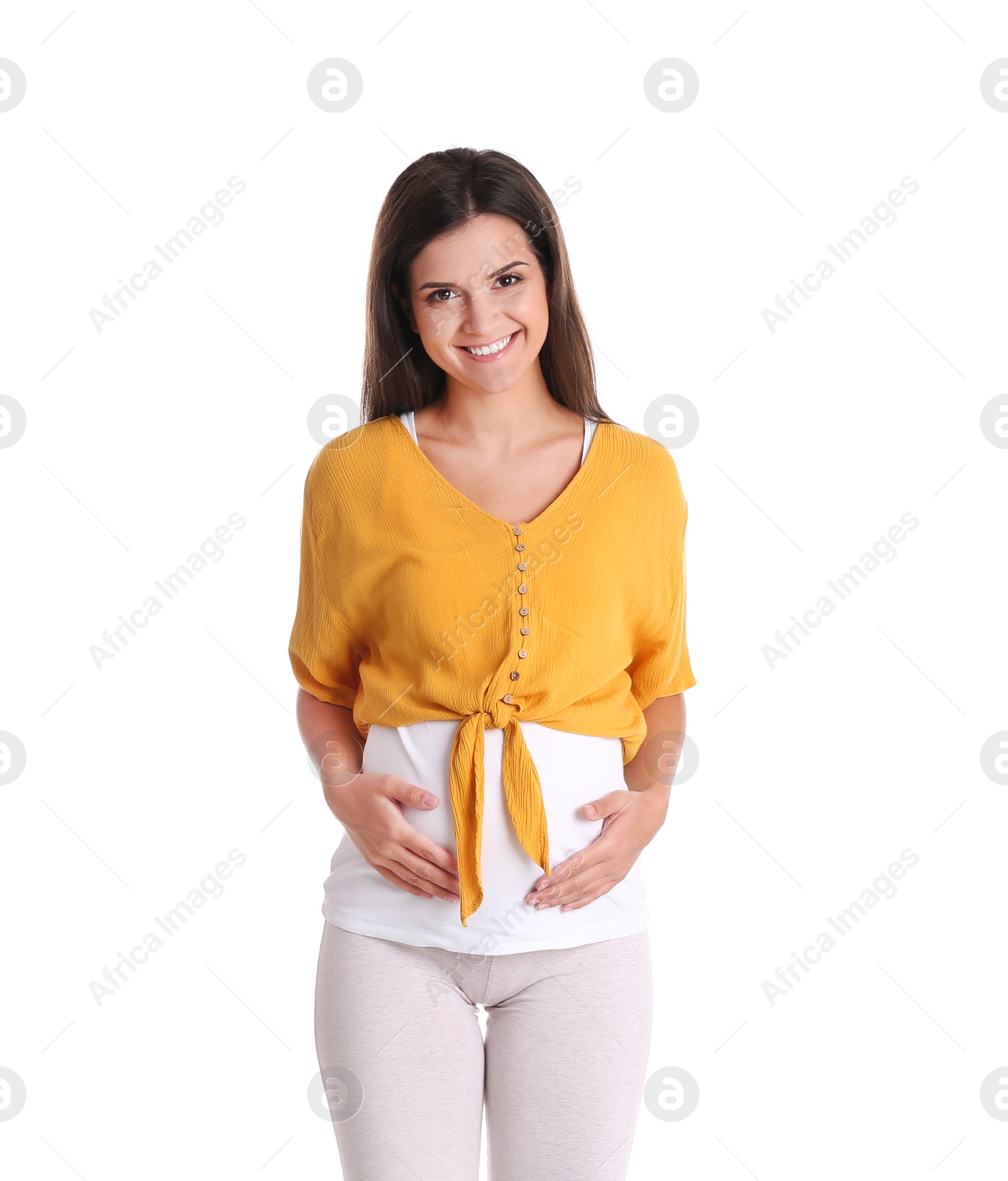 Photo of Happy pregnant woman posing on white background