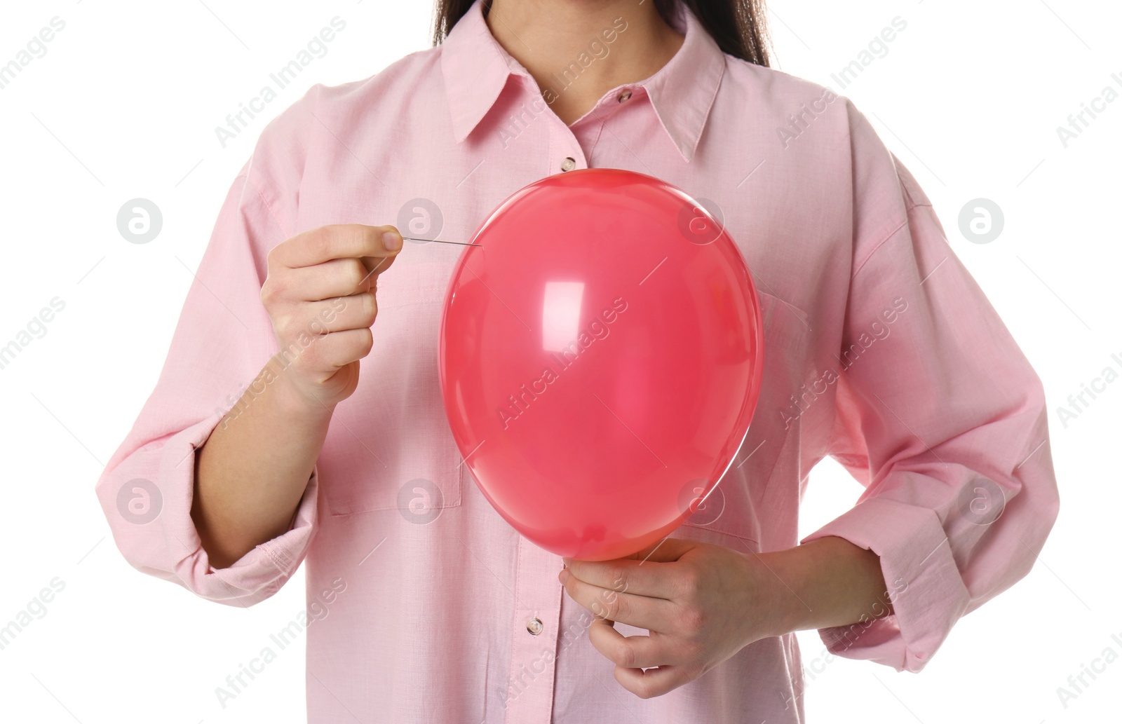 Photo of Woman piercing red balloon on white background, closeup